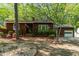 Charming single-story home featuring a well-manicured front yard with mature trees and garden beds at 1801 Irish Blvd, Sanford, NC 27332