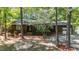 Inviting single-story home featuring an American flag, brick accents, mature trees, and a beautifully landscaped front yard at 1801 Irish Blvd, Sanford, NC 27332