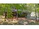 Attractive one-story home with a flag, cozy landscaping, mature trees, and a detached garage providing extra parking space at 1801 Irish Blvd, Sanford, NC 27332