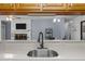 Kitchen sink view to brick fireplace and open living area at 1801 Irish Blvd, Sanford, NC 27332