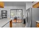 Bright kitchen features stainless steel appliances, light countertops, and sliding glass doors leading to an enclosed patio at 1801 Irish Blvd, Sanford, NC 27332