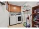 Efficient laundry room with washer, dryer, cabinets, and shelving for storage at 1801 Irish Blvd, Sanford, NC 27332