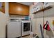 Well-organized laundry room with modern Samsung washer and dryer and upper cabinet storage at 1801 Irish Blvd, Sanford, NC 27332