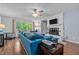Comfortable living room with large window, white fireplace and blue sectional sofa at 1801 Irish Blvd, Sanford, NC 27332