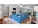 Bright living room featuring hardwood floors, a white brick fireplace and a comfy blue sofa at 1801 Irish Blvd, Sanford, NC 27332