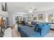 Open concept living room with fireplace, hardwood floors, and large sectional sofa at 1801 Irish Blvd, Sanford, NC 27332