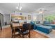 Open-concept living area with dining space, kitchen pass-through, and large blue sectional sofa at 1801 Irish Blvd, Sanford, NC 27332