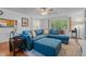 Comfortable living area featuring a large blue sectional, a ceiling fan, and views of the landscaped outdoors at 1801 Irish Blvd, Sanford, NC 27332
