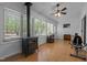 Spacious sunroom with wood burning stove, many windows and ceiling fan at 1801 Irish Blvd, Sanford, NC 27332