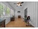 Relaxing sunroom with wood burning stove, many windows, ceiling fan and sliding door at 1801 Irish Blvd, Sanford, NC 27332