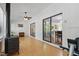 Sunroom featuring wood-look floors, a ceiling fan, and access to the backyard and kitchen at 1801 Irish Blvd, Sanford, NC 27332