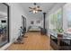 Bright sunroom features wood-burning stove, ceiling fan, day bed, and sliding door to the outside at 1801 Irish Blvd, Sanford, NC 27332