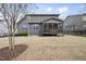 The backyard view showcases the covered porch and the grassy yard at 1916 Edens Ridge Ave, Wake Forest, NC 27587