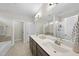 Bathroom featuring double sinks, a large mirror, and a separate shower and bathtub at 1916 Edens Ridge Ave, Wake Forest, NC 27587