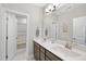 Bathroom featuring double sinks, a large mirror, and a shower with tub at 1916 Edens Ridge Ave, Wake Forest, NC 27587