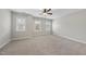 A well-lit bedroom with three windows and neutral carpet at 1916 Edens Ridge Ave, Wake Forest, NC 27587