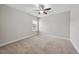 A bright, empty bedroom featuring neutral carpet, a ceiling fan, and a window at 1916 Edens Ridge Ave, Wake Forest, NC 27587