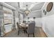 Charming dining room with wainscoting, coffered ceiling, and a stylish chandelier above the round table at 1916 Edens Ridge Ave, Wake Forest, NC 27587