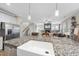 Open concept kitchen with granite counters, island sink, and stainless appliances overlooking living area at 1916 Edens Ridge Ave, Wake Forest, NC 27587
