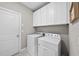 Convenient laundry room with white cabinets and modern washer and dryer at 1916 Edens Ridge Ave, Wake Forest, NC 27587