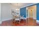 Dining room with hardwood floors, blue accent wall and stylish chandelier, creating a welcoming atmosphere at 201 Finsbury St # 201, Durham, NC 27703