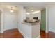 Open concept kitchen features granite counters, stainless appliances, and sage and white cabinets at 201 Finsbury St # 201, Durham, NC 27703