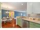 Open kitchen and dining area with stainless steel appliances, granite countertops, and hardwood floors at 201 Finsbury St # 201, Durham, NC 27703
