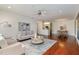 Open-concept living room with hardwood floors, modern furniture, and a view into kitchen and dining area at 201 Finsbury St # 201, Durham, NC 27703