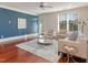 Bright living room featuring hardwood floors, large windows, and modern neutral furnishings at 201 Finsbury St # 201, Durham, NC 27703