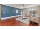Bright living room featuring hardwood floors, a blue accent wall, and natural light at 201 Finsbury St # 201, Durham, NC 27703