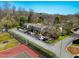 Aerial view of townhomes with parking, tennis court and mature trees in a community setting at 220 Elizabeth St # F-2, Chapel Hill, NC 27514