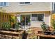 A cozy backyard patio with sliding glass doors, wooden planters, and seating area at 220 Elizabeth St # F-2, Chapel Hill, NC 27514