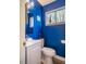 Modern bathroom with bright blue walls, updated vanity, and window view at 220 Elizabeth St # F-2, Chapel Hill, NC 27514