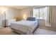 Cozy bedroom with a large window, neutral tones, and ample natural light at 220 Elizabeth St # F-2, Chapel Hill, NC 27514
