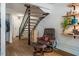 Inviting entryway featuring a comfortable chair, stylish decor, and staircase to the upper level at 220 Elizabeth St # F-2, Chapel Hill, NC 27514