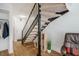 Inviting entryway featuring wood floors, a coat closet, and a carpeted staircase at 220 Elizabeth St # F-2, Chapel Hill, NC 27514
