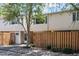 Charming townhouse with a wooden fence and mature tree in the front yard at 220 Elizabeth St # F-2, Chapel Hill, NC 27514
