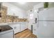 Clean kitchen features white cabinets, modern appliances, and tile backsplash at 220 Elizabeth St # F-2, Chapel Hill, NC 27514