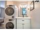 Modern laundry room featuring a stacked washer and dryer and an updated vanity at 220 Elizabeth St # F-2, Chapel Hill, NC 27514