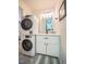 Functional laundry room with a stacked washer/dryer and modern sink and vanity at 220 Elizabeth St # F-2, Chapel Hill, NC 27514