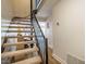 Staircase with carpeted steps and black iron railing leads to the upper level at 220 Elizabeth St # F-2, Chapel Hill, NC 27514