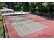 Aerial view of a tennis court, showcasing the net, court lines, and surrounding amenities at 220 Elizabeth St # F-2, Chapel Hill, NC 27514