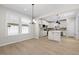 Open dining room featuring hardwood floors with view of kitchen with island and pendant lighting at 2340 Beeblossom Pl, Fuquay Varina, NC 27526