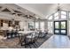 This open kitchen and dining area is bathed in natural light, complete with modern furnishings and an inviting atmosphere at 2340 Beeblossom Pl, Fuquay Varina, NC 27526