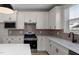 Bright kitchen with white cabinets, stainless steel appliances, and tile backsplash at 2340 Beeblossom Pl, Fuquay Varina, NC 27526