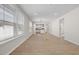 Open-concept living room with wood floors, large windows and plenty of natural light at 2340 Beeblossom Pl, Fuquay Varina, NC 27526