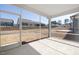 A screened porch with a concrete floor and a serene view of the backyard and neighborhood at 2340 Beeblossom Pl, Fuquay Varina, NC 27526