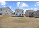 View of backyard showing the patio, landscaping, and exterior of the home, nestled between neighbors at 25 Carlton Ln, Franklinton, NC 27525