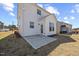 Exterior view of home showcasing the backyard with a concrete patio and white vinyl siding at 25 Carlton Ln, Franklinton, NC 27525