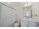 Clean bathroom featuring a vanity with white cabinets, a full mirror, and a shower with a leaf pattern curtain at 25 Carlton Ln, Franklinton, NC 27525